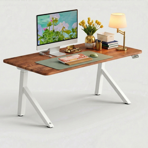 FlowDesk Aero white standing desk styled home office — iMac, mechanical keyboard, yellow flowers and warm table lamp