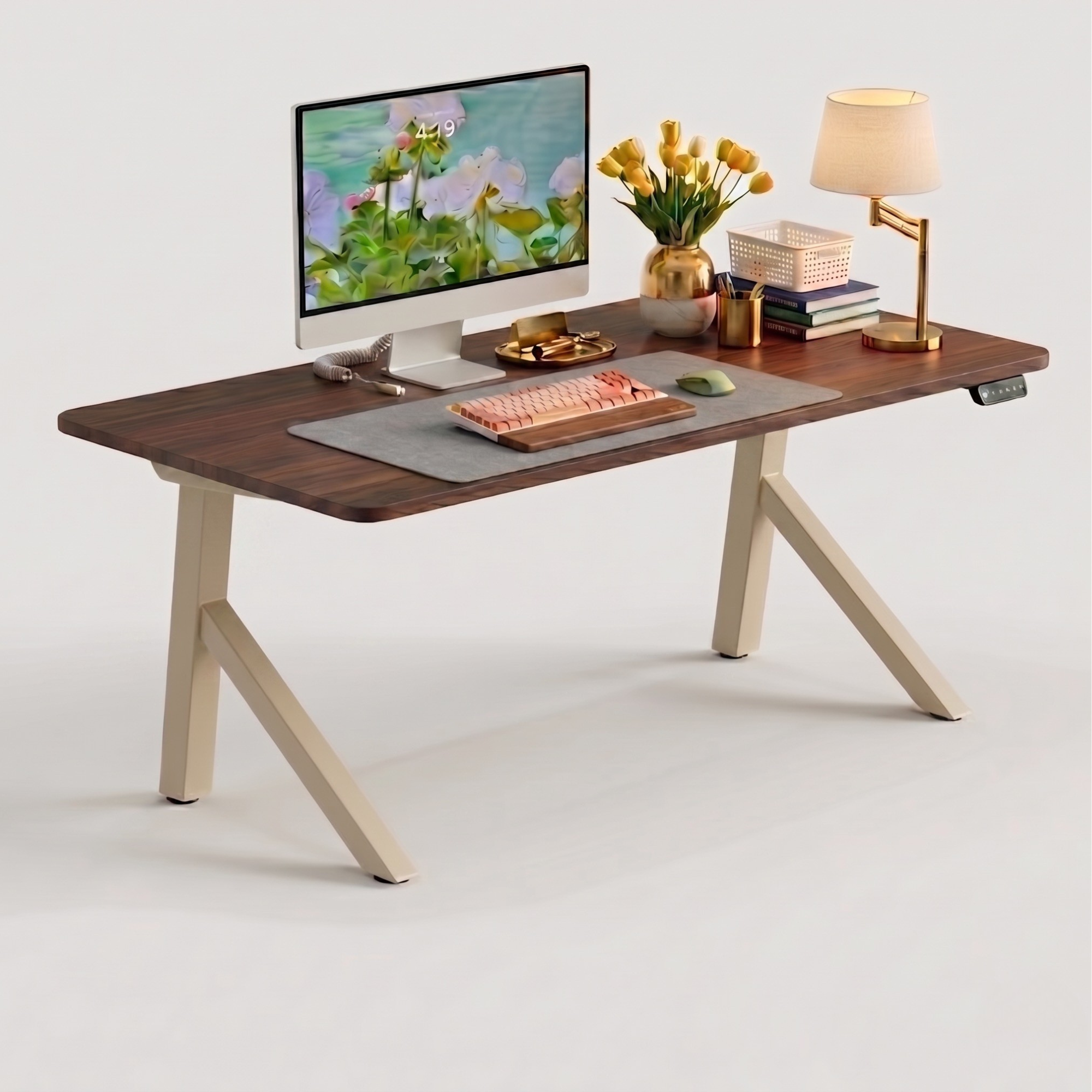 FlowDesk Aero beige standing desk lifestyle image with iMac, mechanical keyboard, flower vase and warm lamp in home office setup
