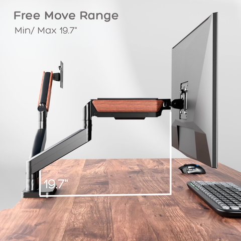 Dual Wooden monitor arm on a desk with computer setup, showing free move range.
